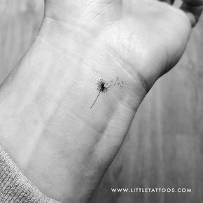 a black and white photo of a dandelion on the wrist