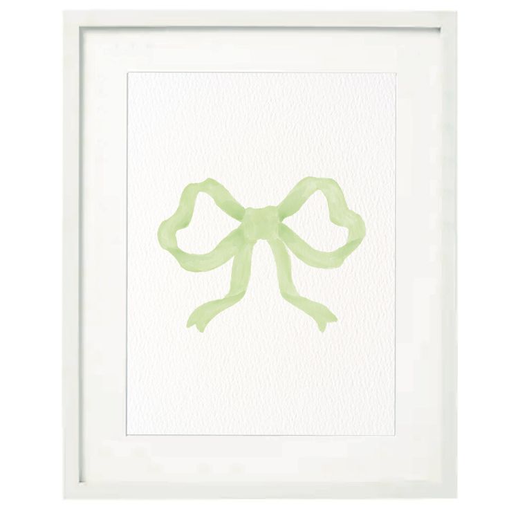 a green bow is hanging in a white frame with watercolor paint on it's paper