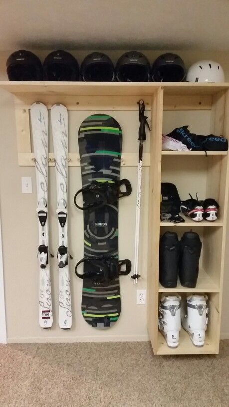 there is a snowboard and skis on the shelf in this room with other items