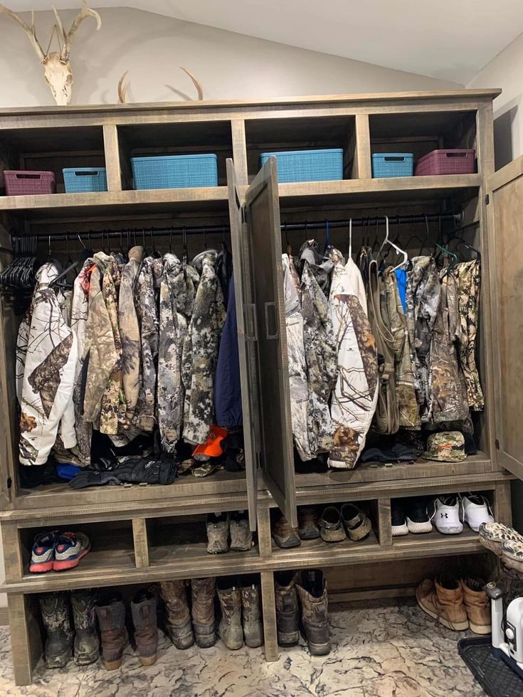 a closet filled with lots of different types of clothes and shoes on top of wooden shelves