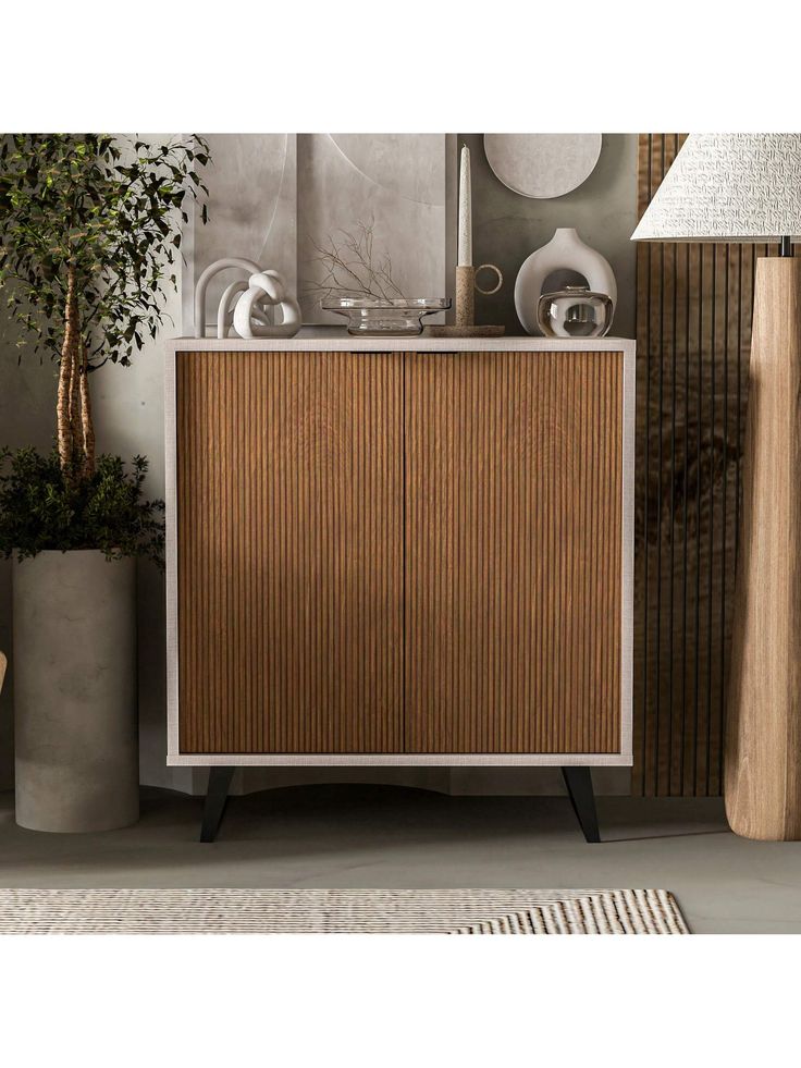 a white and brown cabinet next to a lamp