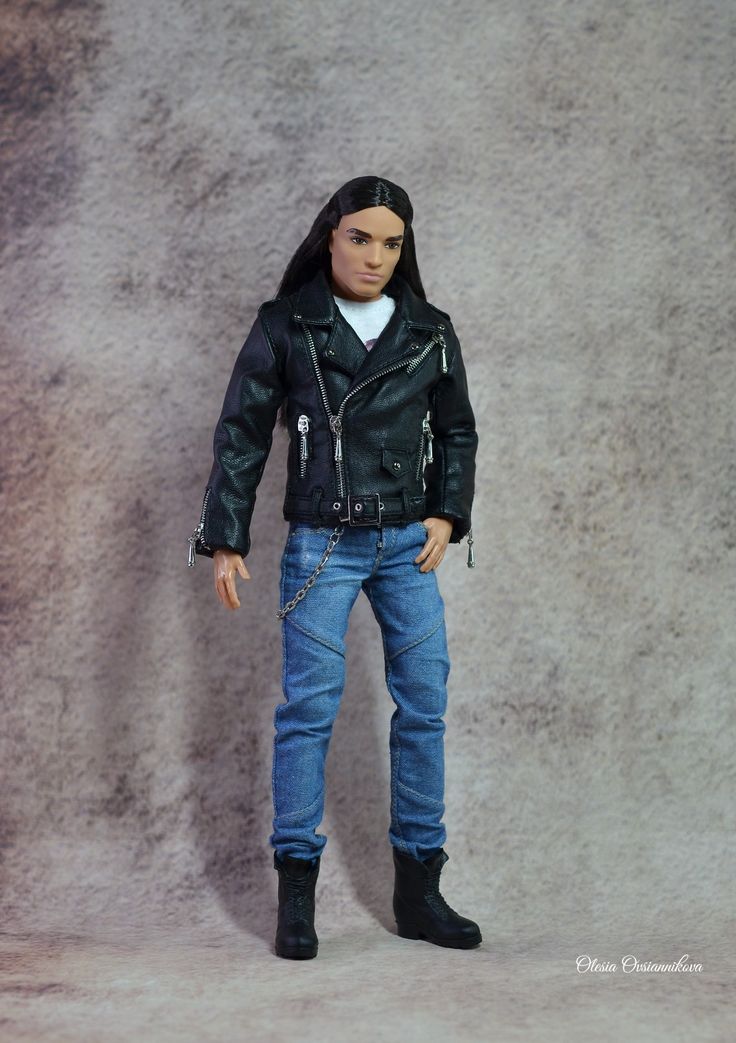 a doll is wearing a leather jacket and jeans