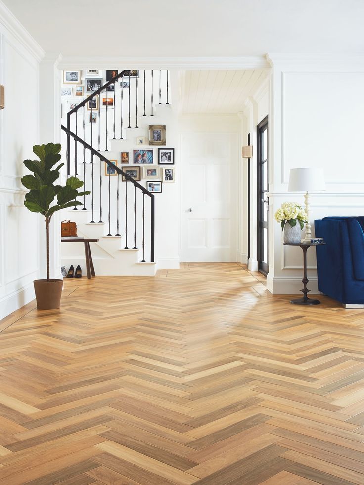 a living room filled with furniture and a wooden floor