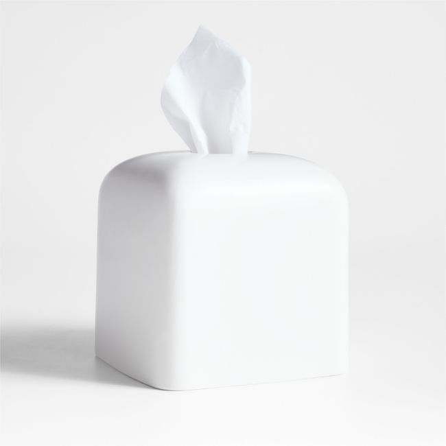 a white tissue dispenser sitting on top of a table