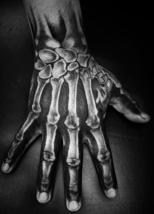 a black and white photo of someones hand with bones on the inside of it