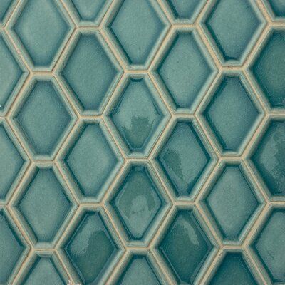 a close up view of a blue tile wall with hexagonal tiles on it