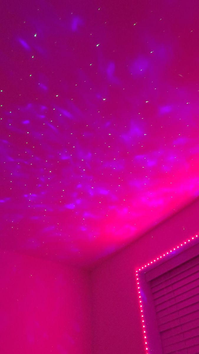 the ceiling is covered in pink lights and stars