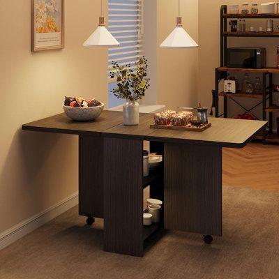 a dining room table with food on it and two lamps hanging from the ceiling above