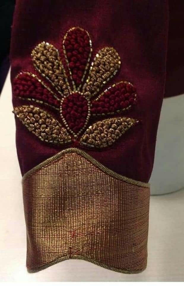 a close up of a purse on a table with red and gold trimmings