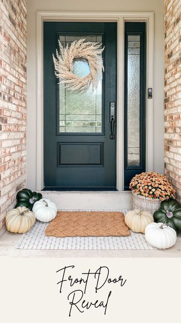 the front door is decorated for fall with pumpkins and gourds