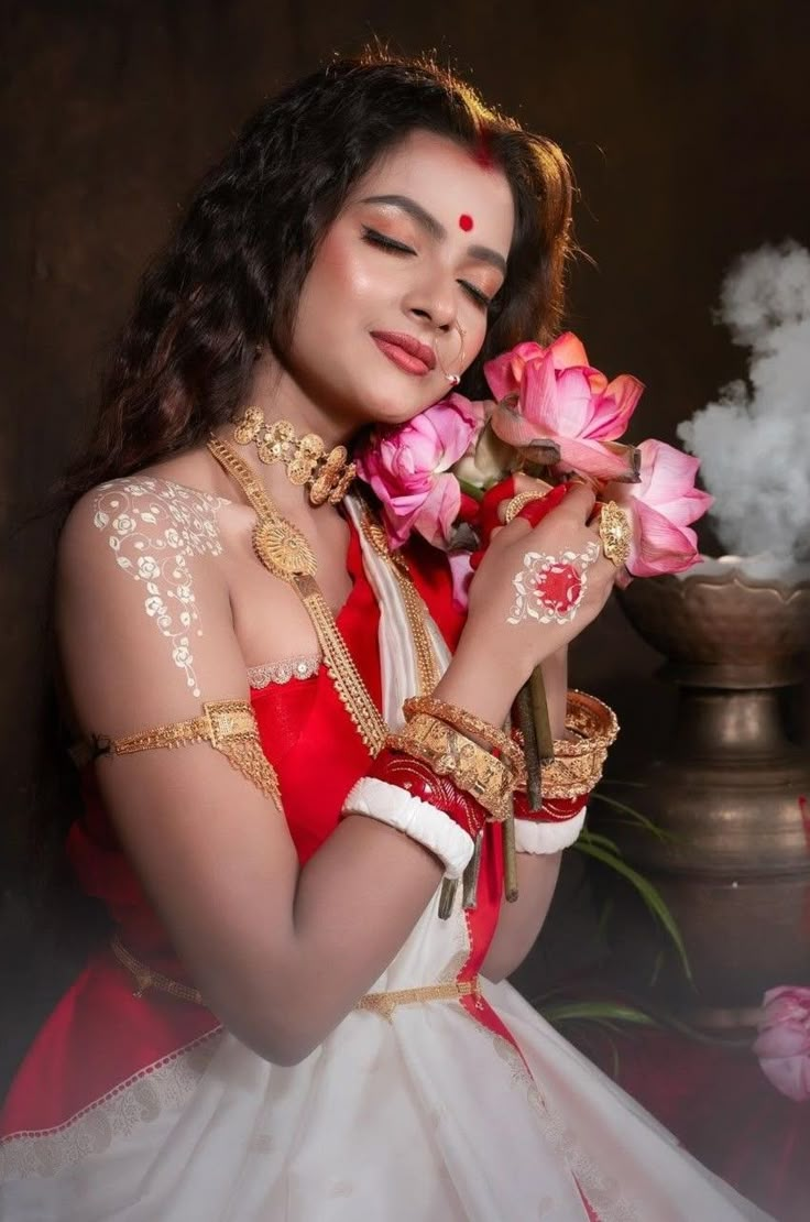 a woman in a white and red dress holding pink flowers