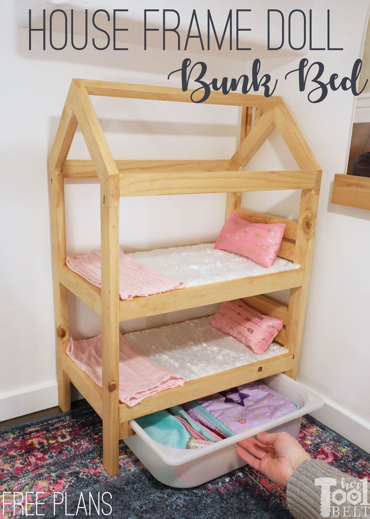 a child's wooden bunk bed with pink and white sheets on it, next to a rug