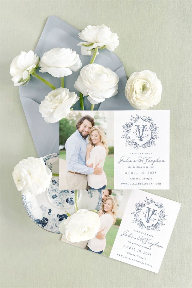 the wedding stationery is laid out on top of a blue and white plate with flowers