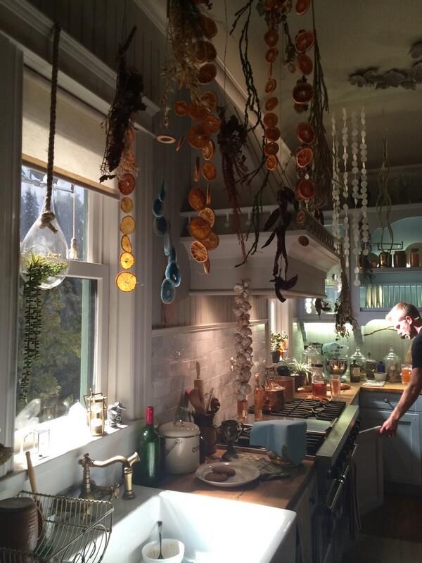 a kitchen filled with lots of hanging objects