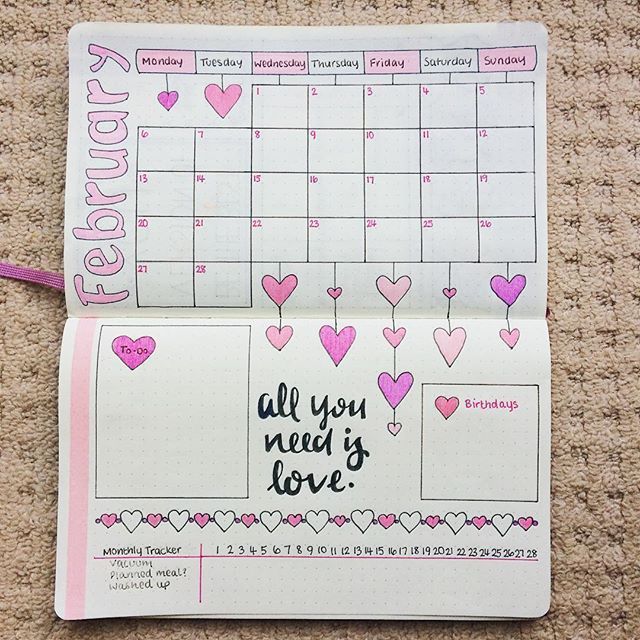 an open planner with hearts on it and the words all you need is love written in pink