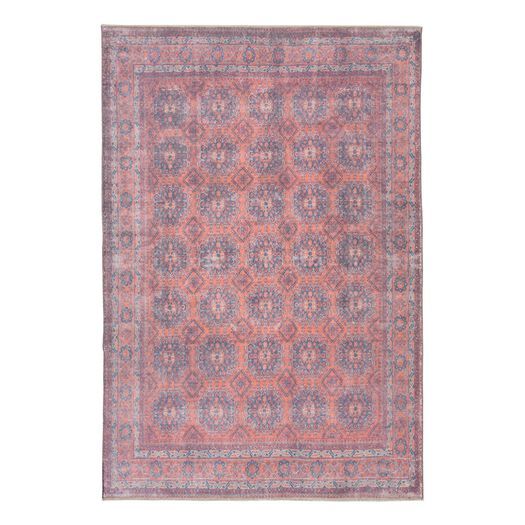 an antique rug with pink and blue colors on the bottom, it is made out of wool