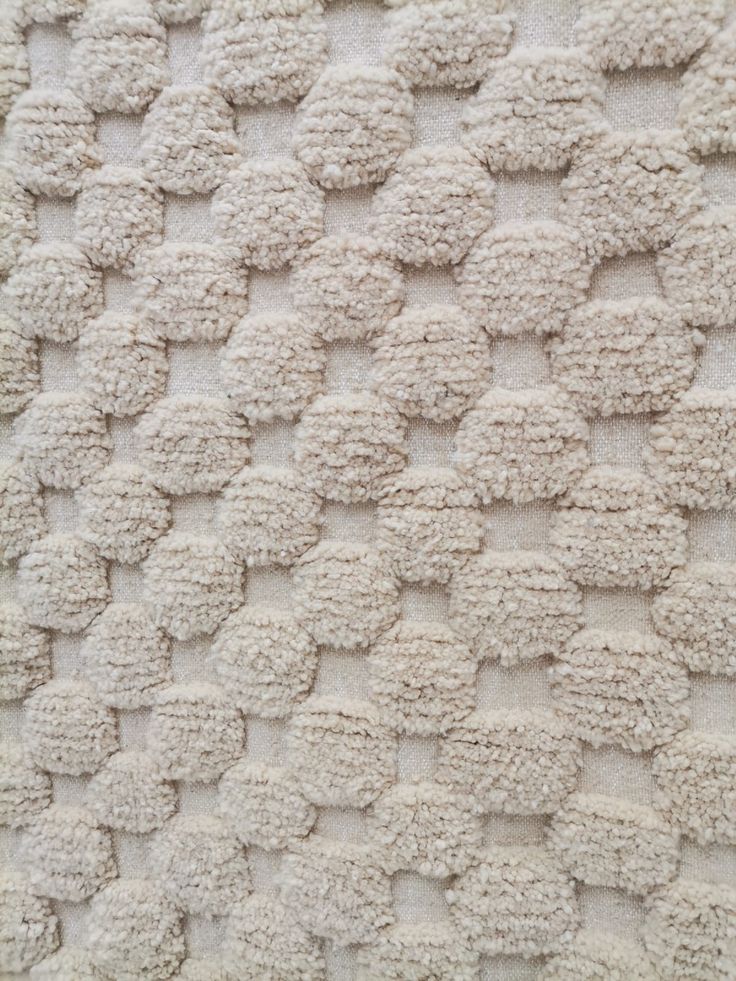 a close up view of a white rug