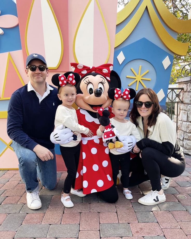 a family poses for a photo with minnie mouse