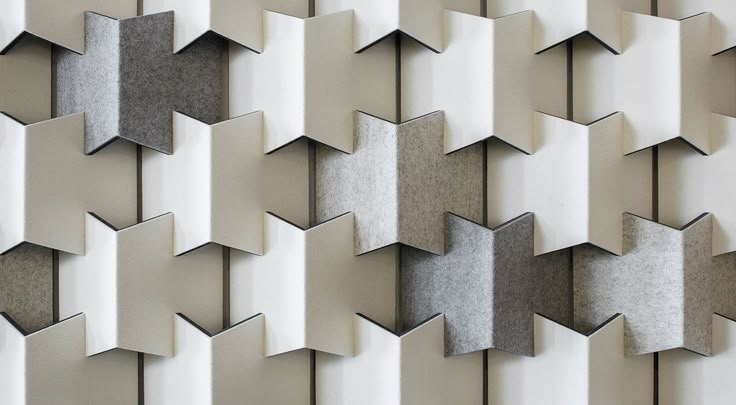 an abstract wall sculpture made out of various shapes and sizes, including star shaped tiles