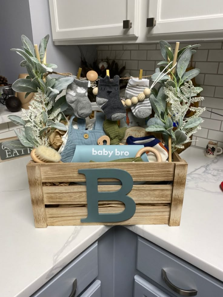 a wooden crate filled with baby toys on top of a kitchen counter