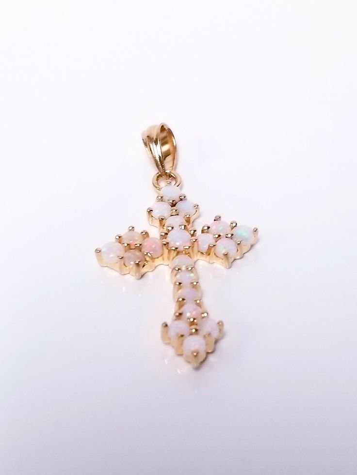 Thanks for shopping our vintage estate store. We tend to sell well below wholesale and truly hope you enjoy all of our items. Many of the items are one of a kind, so please enjoy scrolling through the pictures and hopefully something will catch your eye. Spots are from the camera or reflections. Beautiful 14k yellow gold natural opal victorian style cross pendant. Beautiful color in the opals, hard to see in the pictures. Length: 1.25" Width: 3/4" Weight: 2.19 grams Bail: 1.5mm Marked 14k, as all our gold is marked and tested to be real gold. As with most estate items there may be some wear on item. We do not sell new items, nor do we charge new retail prices. Christ Cross, The Cross Of Christ, Natural Opal, Victorian Style, Victorian Fashion, Real Gold, Cross Pendant, Beautiful Colors, Jewelry Necklace Pendant