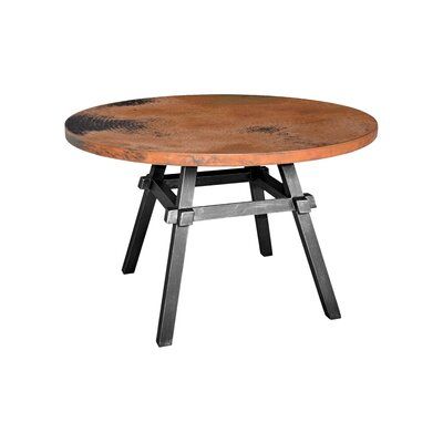 an old wooden table with metal legs and a round top, on a white background