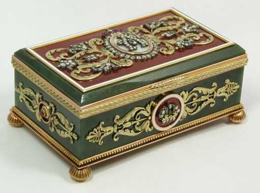 a green and gold box with ornate designs on it