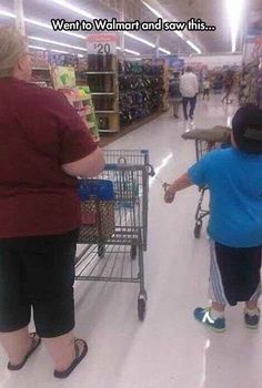 a woman pushing a shopping cart with a child in it while another person pushes a shopping cart behind her