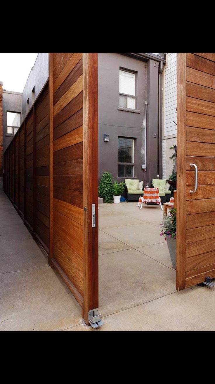 two wooden doors open on the outside of a house