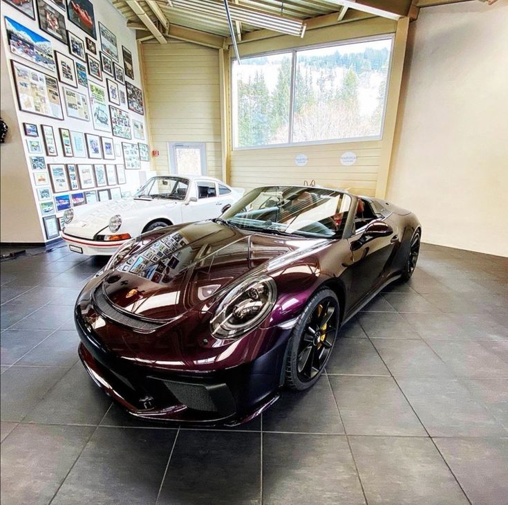 two sports cars are parked in a showroom