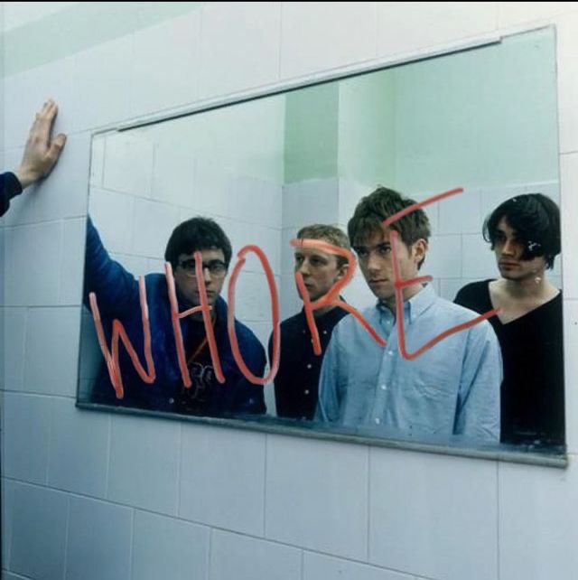 a group of young men standing in front of a mirror with the word who written on it