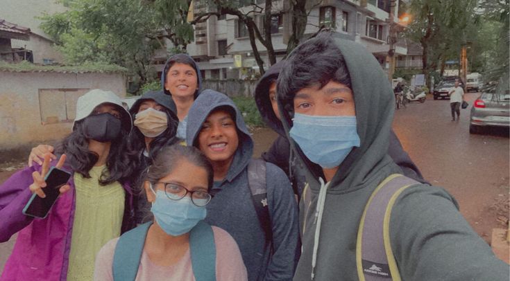 a group of people wearing face masks on the street