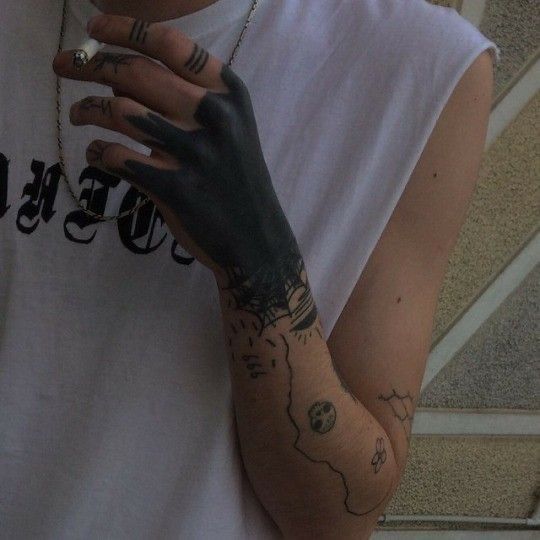 a person with tattoos on their arms and hands