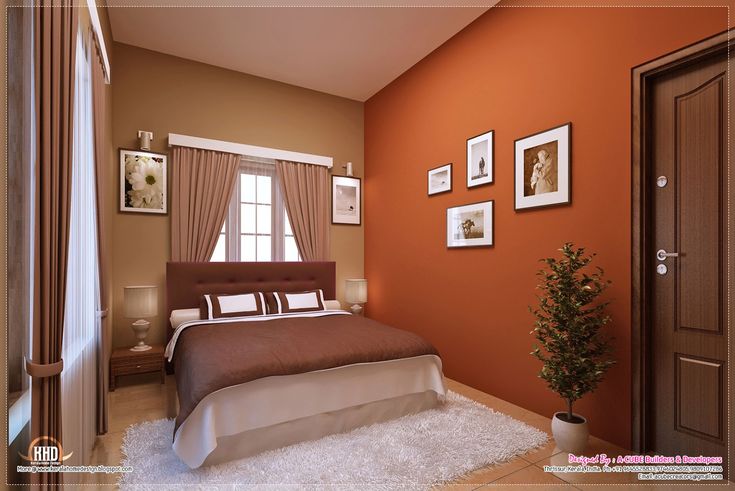 a bedroom with an orange wall and white carpet