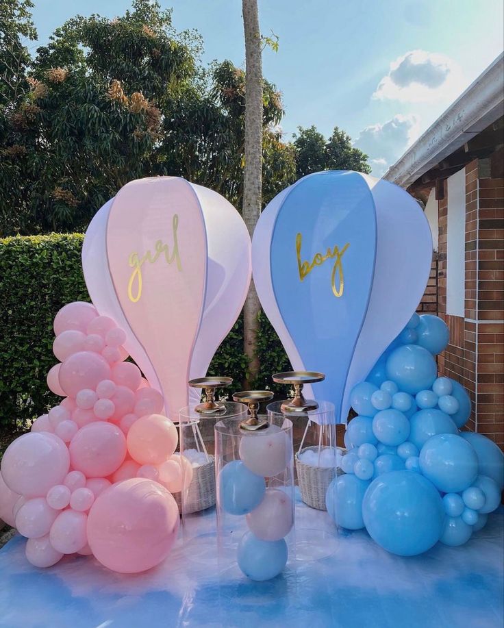 some balloons are sitting on a table outside