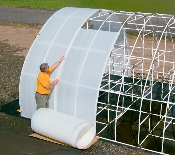 a man standing next to a large white structure