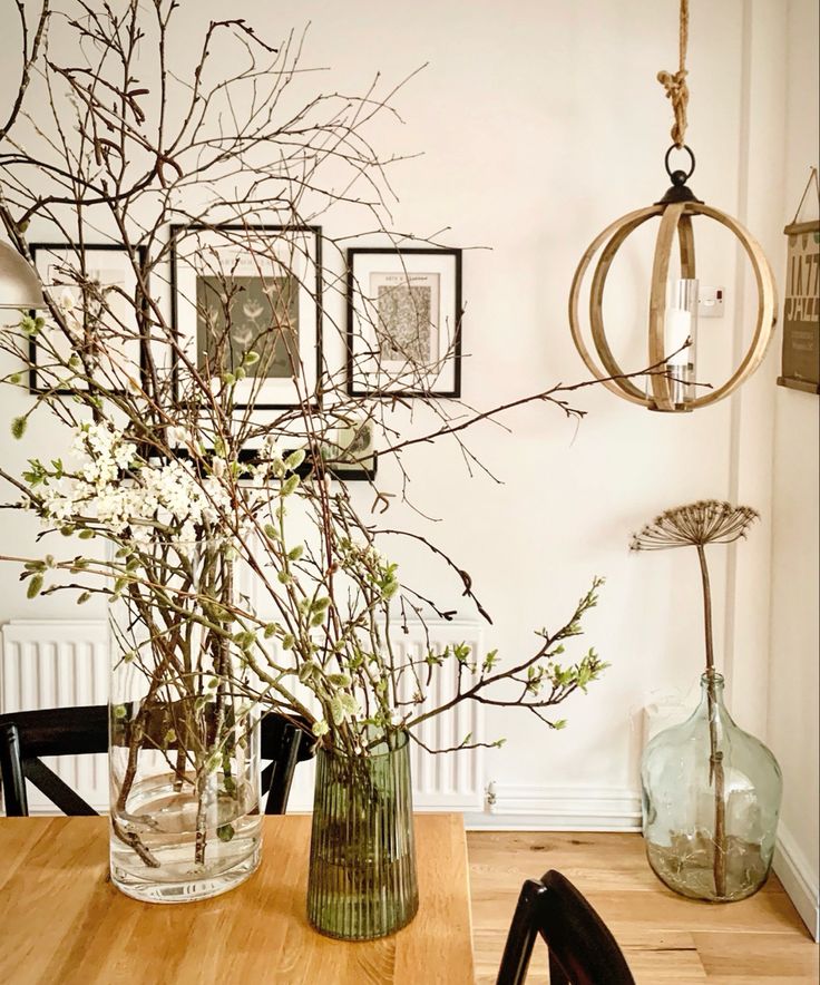 a vase filled with flowers sitting on top of a wooden table