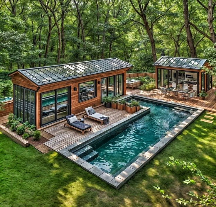 a small pool surrounded by lush green trees and lawn furniture next to the swimming pool