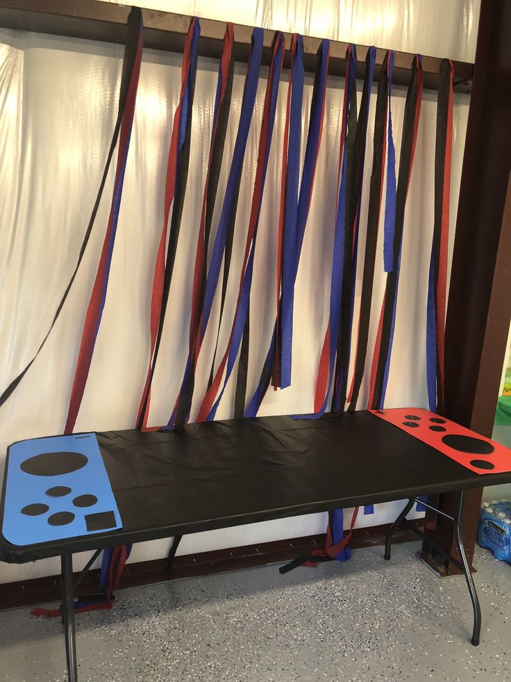 a black table with red, white and blue ribbons hanging from it's sides