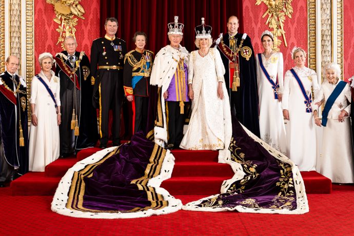 the royal family poses for a group photo in front of red curtains and gold decorations