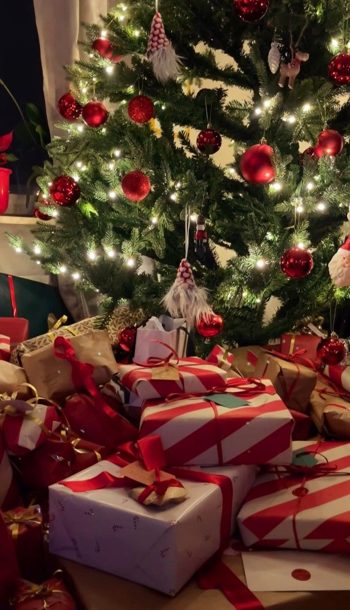 a christmas tree with presents under it