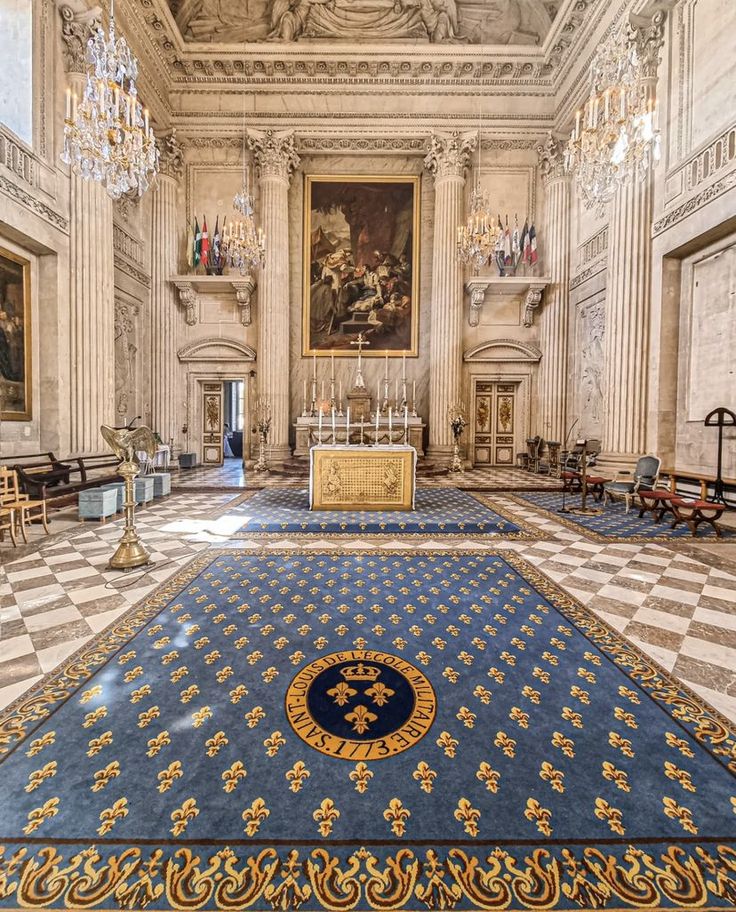 an ornate room with chandeliers and paintings on the walls, in front of a marble floor