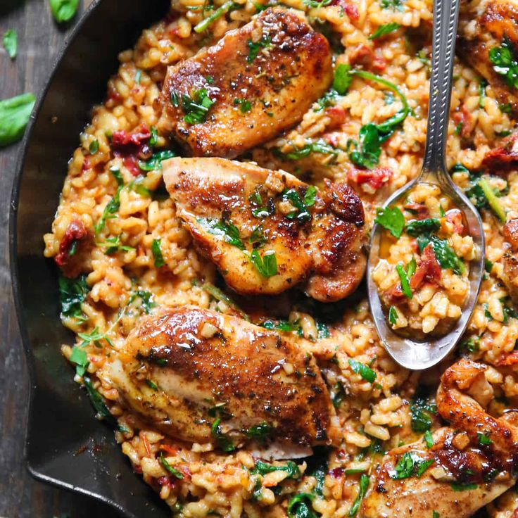 a skillet filled with chicken and rice