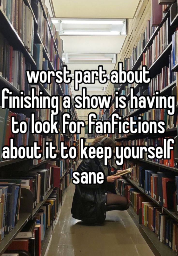 a person sitting on the floor in a library with bookshelves and shelves full of books