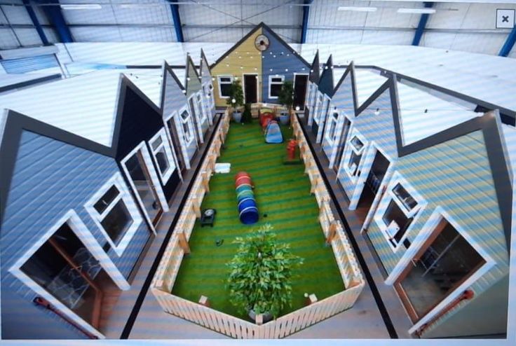 an aerial view of a building with artificial turf in the center and several windows on each side