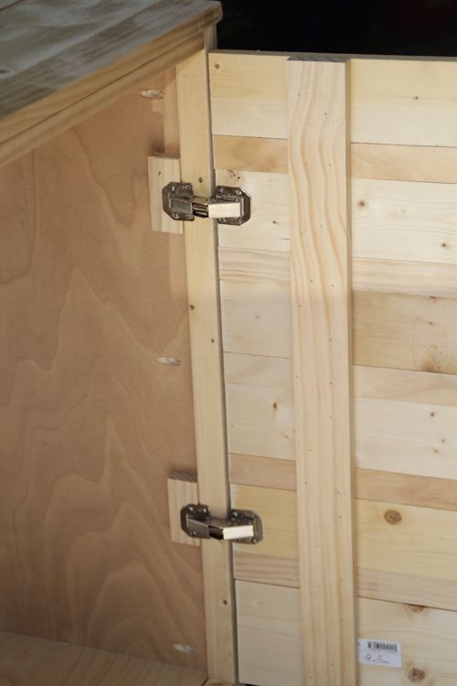 the inside of a wooden cabin with metal handles