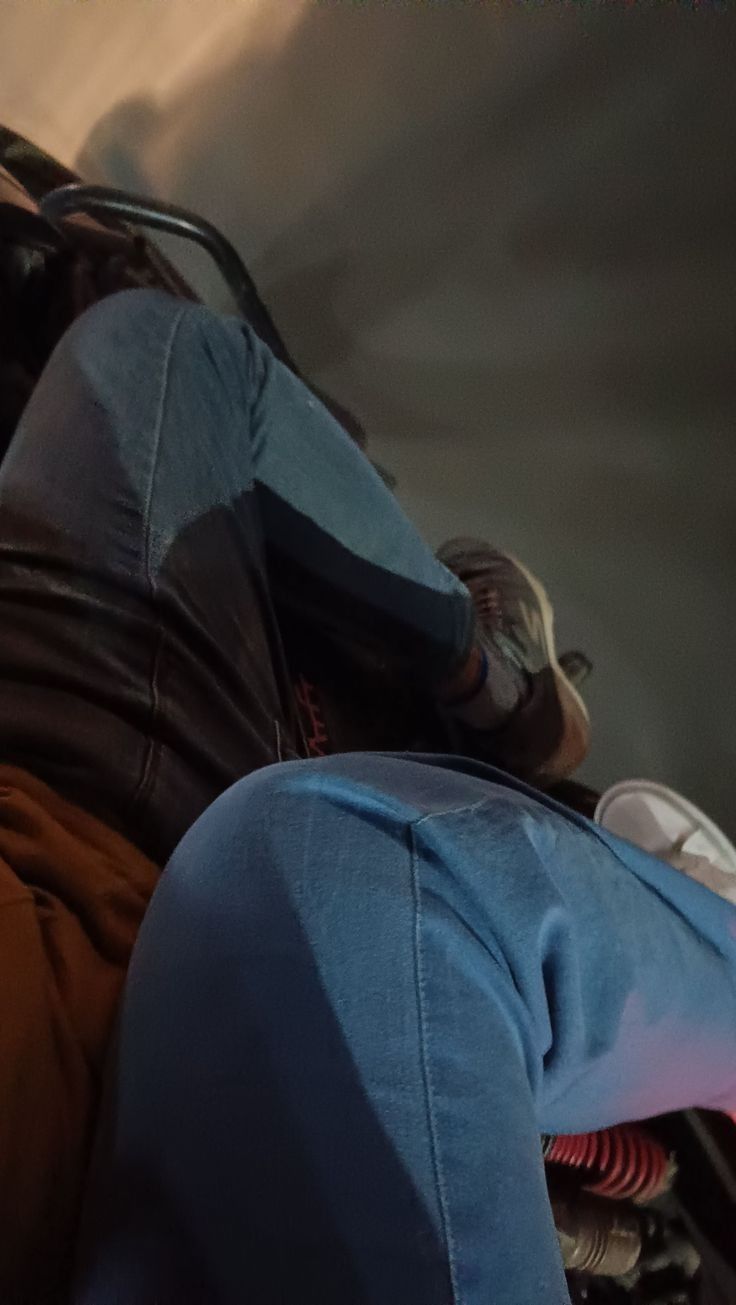 a man laying on top of a couch next to a fire hydrant in front of him