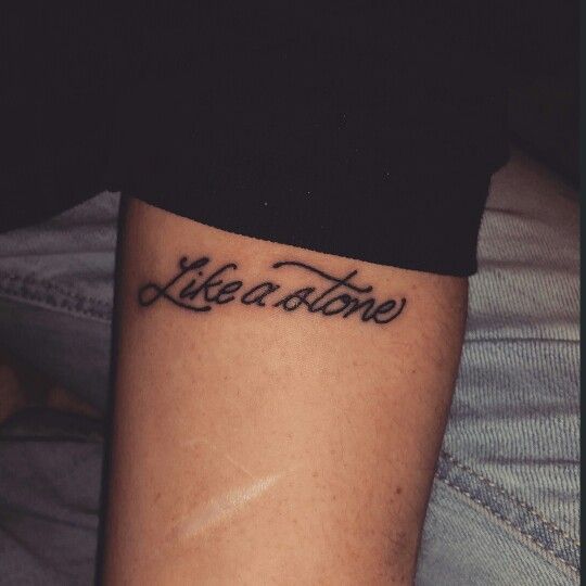 a woman with a tattoo on her leg that says,'liberation'in cursive writing