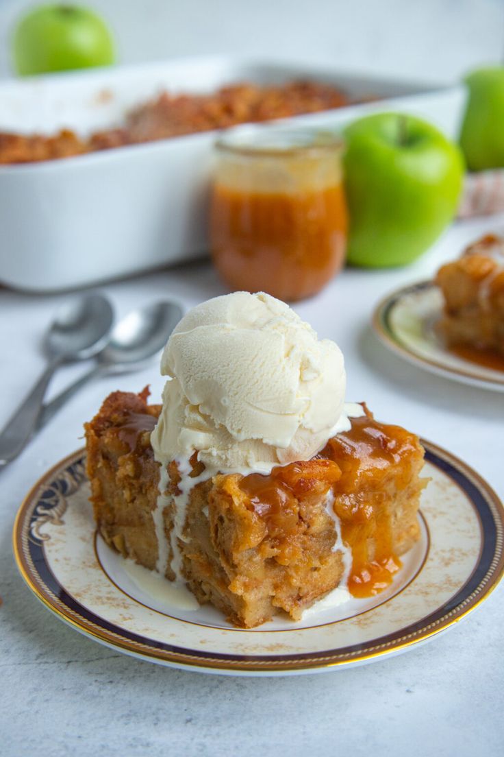 a piece of cake on a plate with ice cream and caramel sauce in the background