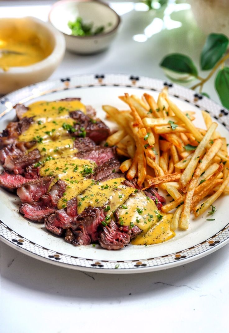 steak and french fries are served on a plate